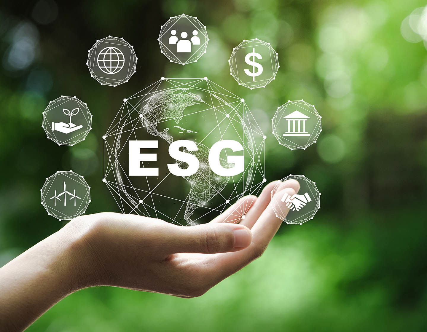 ESG globe in a person hands on a green background
